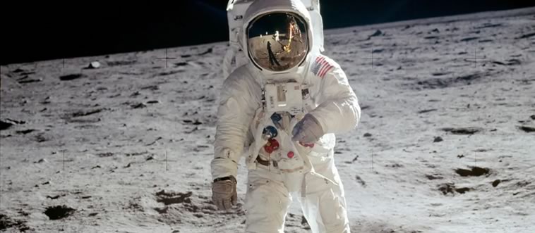 A mystery man in a spacesuit makes his grand debut on a gray, cratered stage while planting a flag. Which iconic event is this?