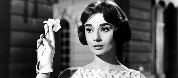 Can you name the ultimate fashion icon serving timeless elegance in this portrait?